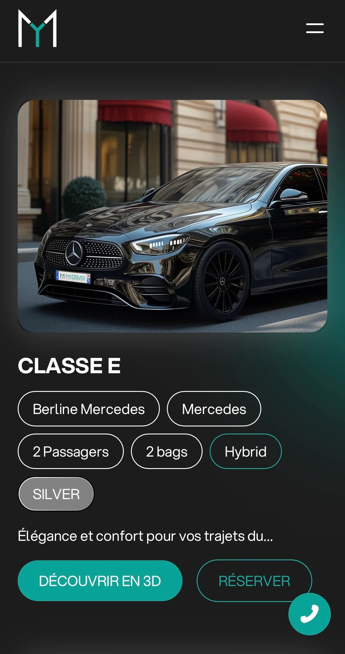 Black Mercedes Benz E-Class sedan parked on a city street with red awnings in the background.